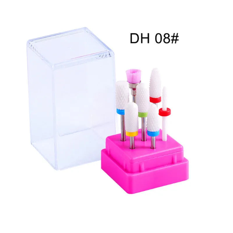 Set of seven tungsten steel nail drill bits and a brush in a clear plastic case.