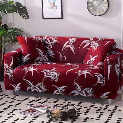 Geometric abstract printed stretch sofa slipcover covering a three-seater sofa with matching cushion covers.