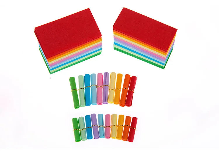 Assorted colourful paper scrolls with metal eyelets for messages and craft projects.