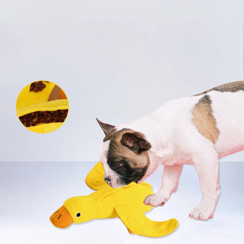 Yellow plush duck dog toy with a sound module and treat-dispensing openings.