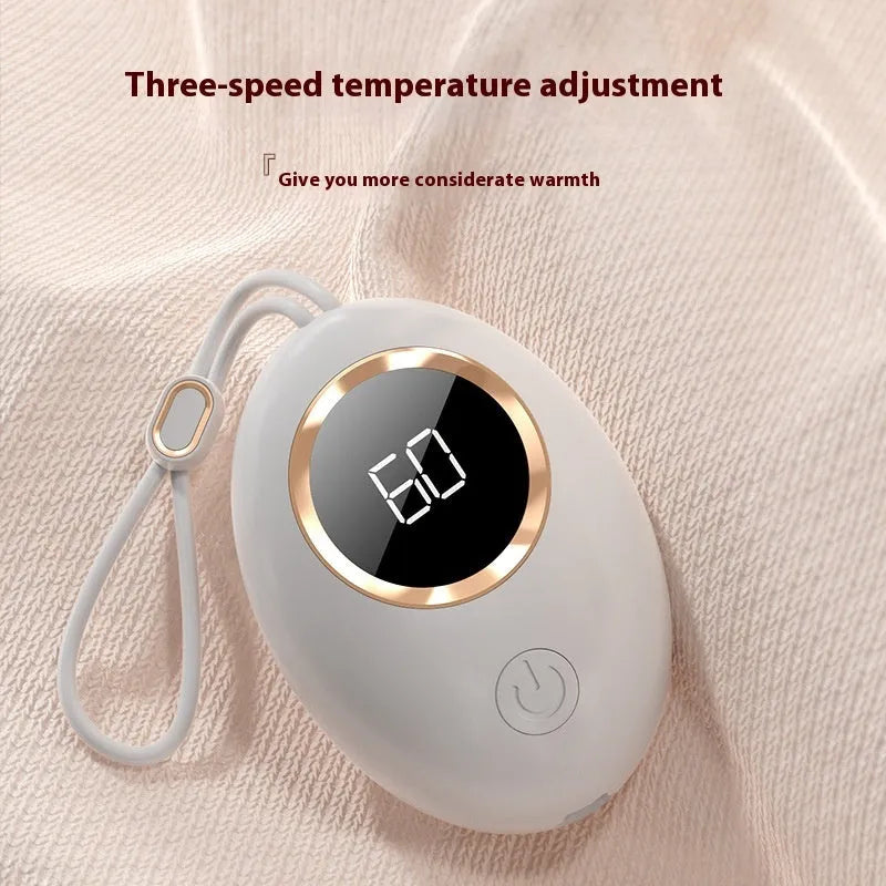 USB digital display hand warmer in pink, showing aluminium heating pad and screen