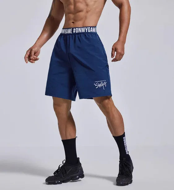 Men's loose grey athletic shorts with an elastic fly opening and letter print, shown from the front.