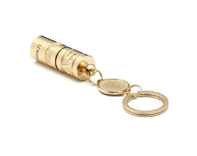 Gold-coloured zinc alloy waterproof mini LED flashlight on a keychain.