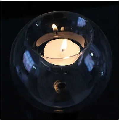 Handmade round hollow clear glass candle holder with a tea light inside, showing European style design.