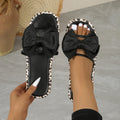 Black leopard print scaffold-shaped beach slippers with thick sole and round toe on white background