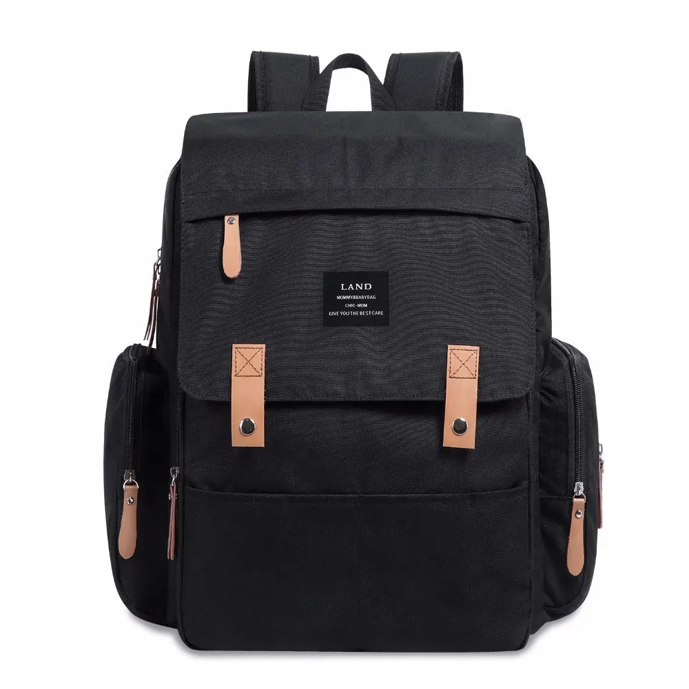 LAND Mommy large grey diaper backpack with changing mat, shown with baby care items.