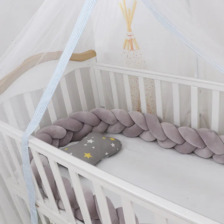 Braided spandex velvet baby bumper shown in a light grey colour, flexed to show its bendable design.