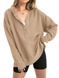 Women's loose fit raglan sleeve sweater in peacock green, shown on a model.