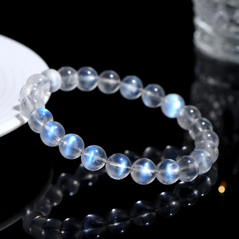 Natural cream body crystal bracelet with spherical beads on a wrist, showing minimalist unisex design.