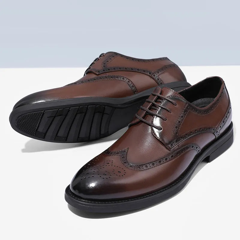 Men's classic black and brown brogue leather shoes with wingtip design on a white background.