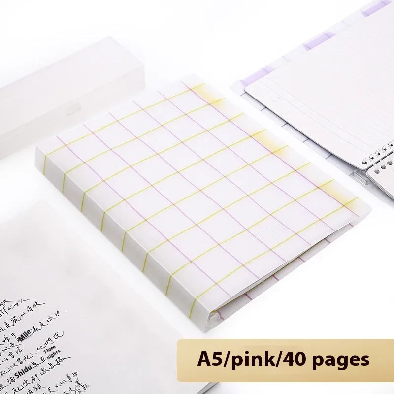 Refillable loose-leaf spiral notebook with PP cover open, showing raw wood pulp paper in grid ruling.