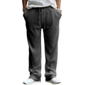 Man wearing loose-fit, high-waist, straight-leg casual trousers in a striped pattern.