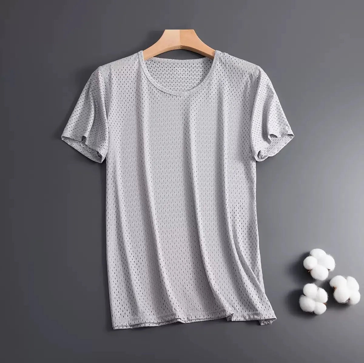 Man wearing ice silk short sleeve crew neck t-shirt in solid colour with thin mesh fabric