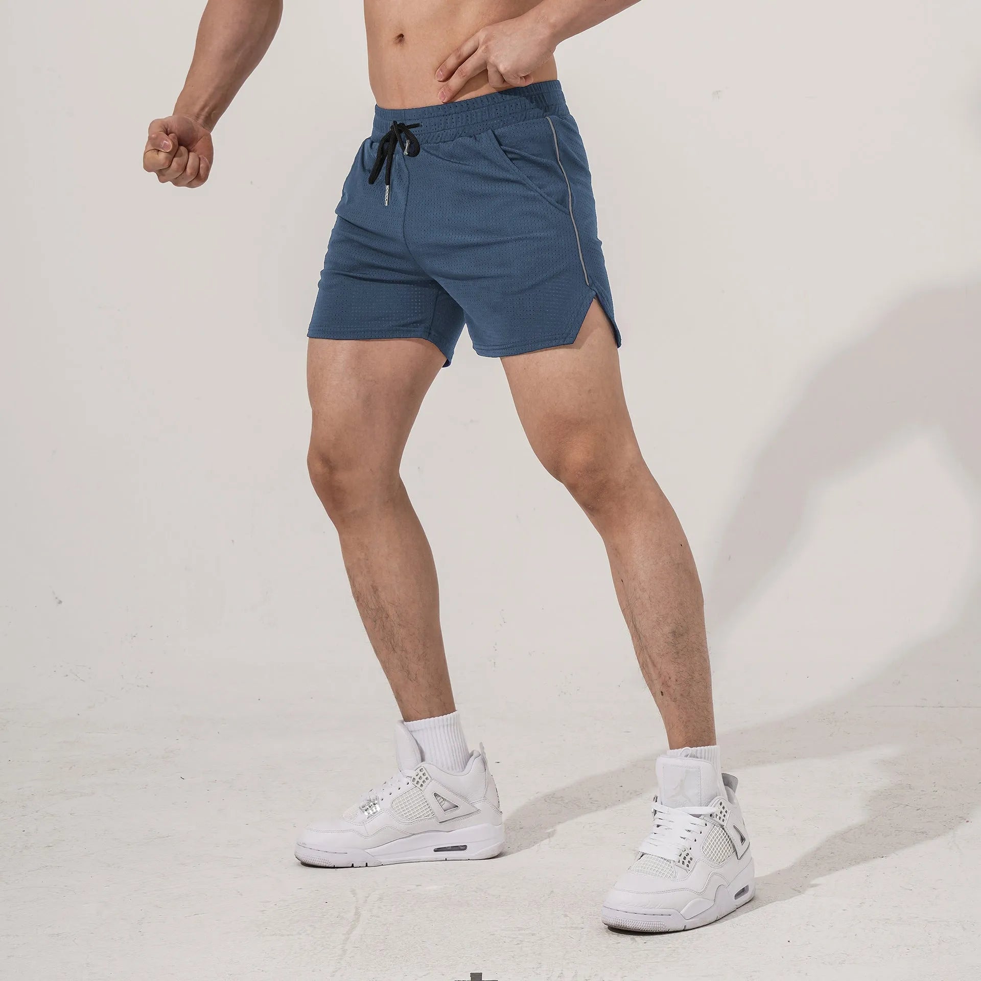 Men's straight-leg polyester sports shorts in black, shown flat.