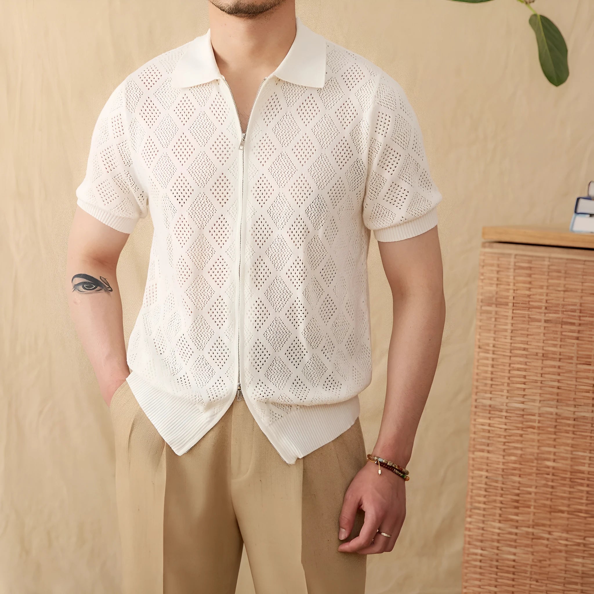 Light brown short sleeve zip-up cardigan with a lapel collar laid flat.