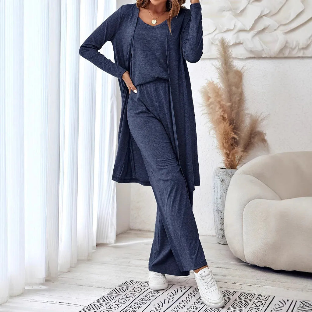 Blue women's three-piece suit set with sling top, long cardigan and trousers on hanger