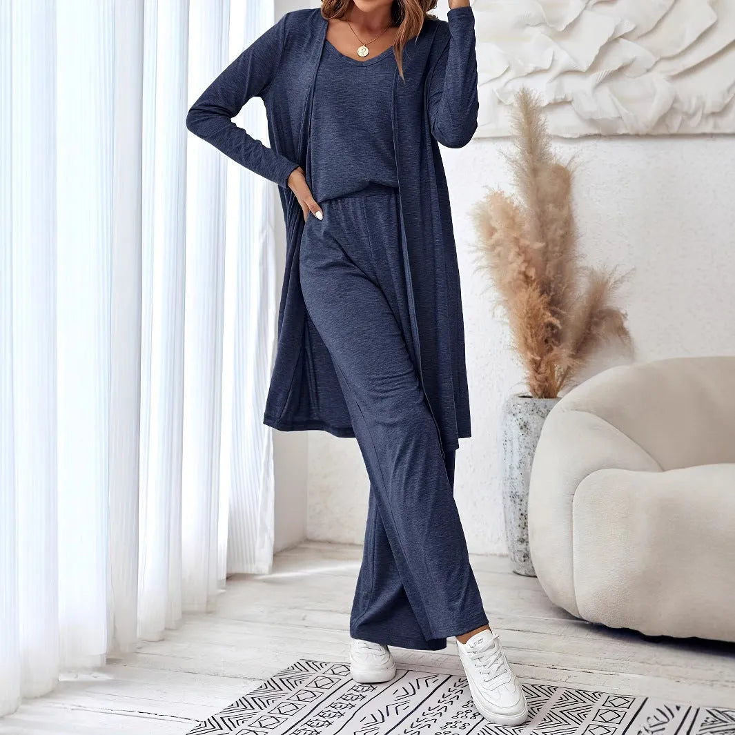 Blue women's three-piece suit set with sling top, long cardigan and trousers on hanger
