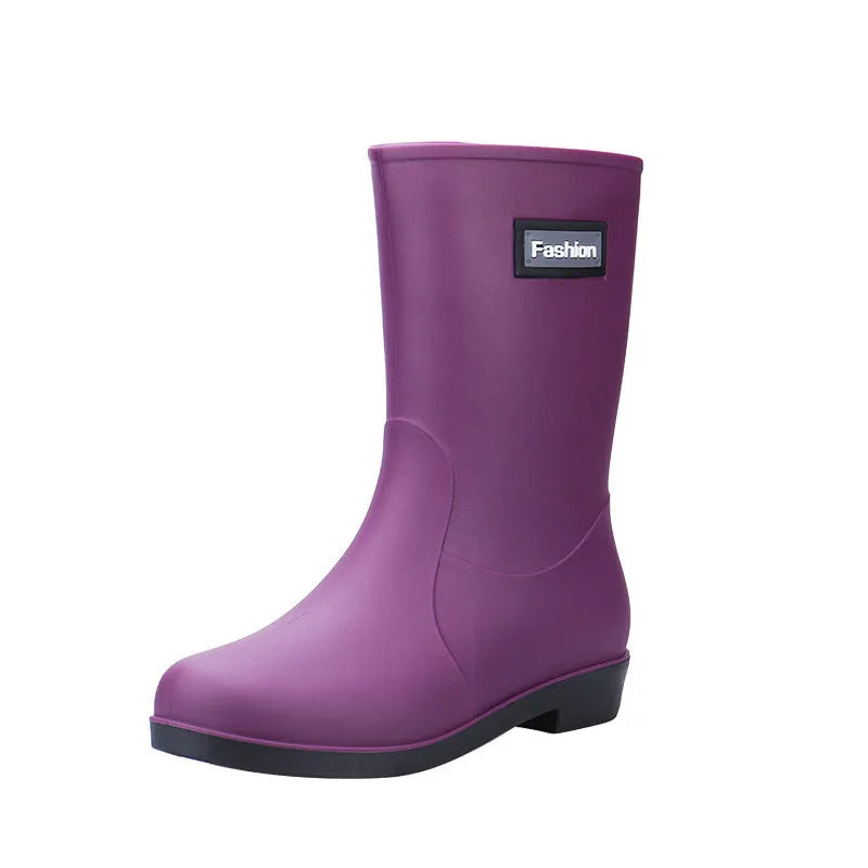 Women's mid-calf PVC rain boot in black with a low heel on a white background.