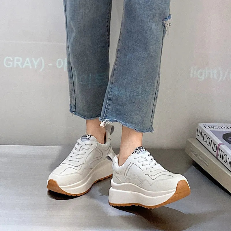 Beige women's low-top leather shoes with cross-strap detail and English muffin heel.