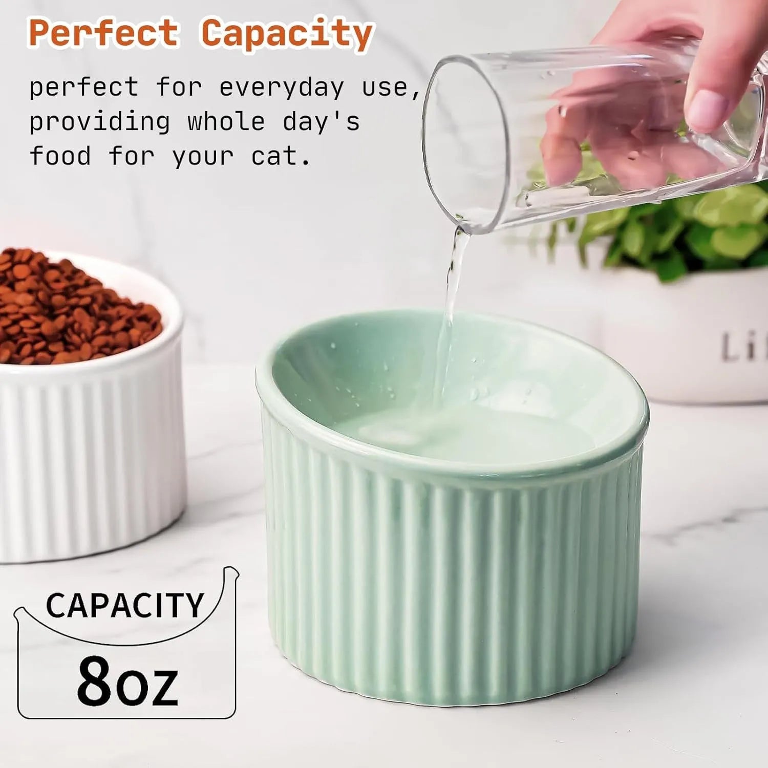 A dark green round ceramic cat bowl elevated on a base, shown at an angle.