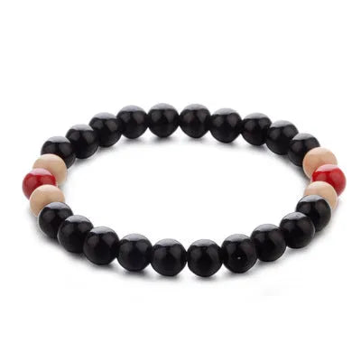 Natural stone beaded bracelet with lava stone beads on wrist, showing ethnic design and essential oil application