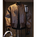 Man modelling a slim-fit black PU leather jacket with litchi grain texture and extended length.