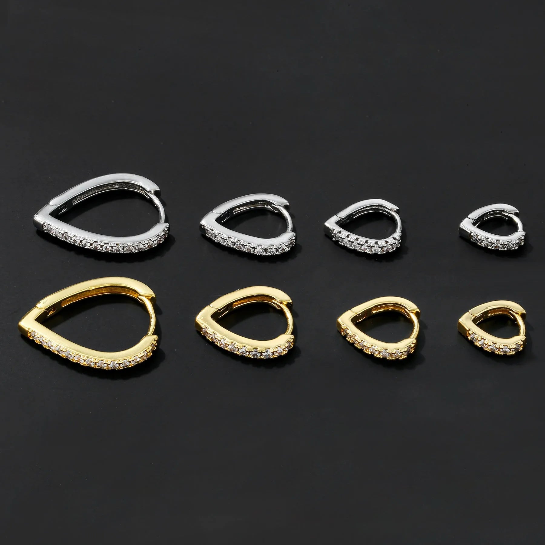 Geometric heart-shaped copper ear clip with electroplated gold finish on a white background.