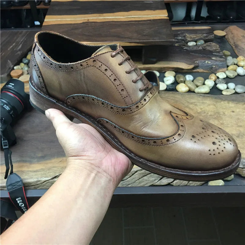 Men's light brown vintage distressed leather casual shoes with engraved detailing and round toe.