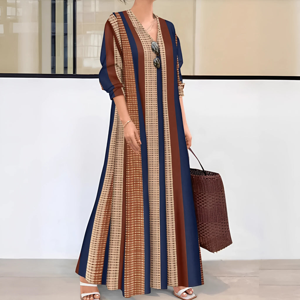 Camel-coloured women's long dress with vertical stripes, V-neck collar, and long sleeves on a mannequin.