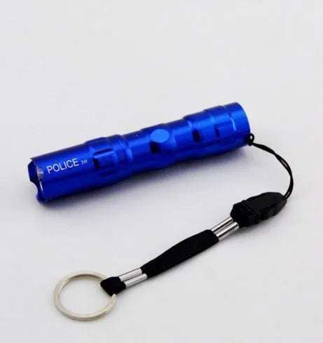 Small black aluminium LED flashlight with a strong beam, shown next to a AA battery for scale.