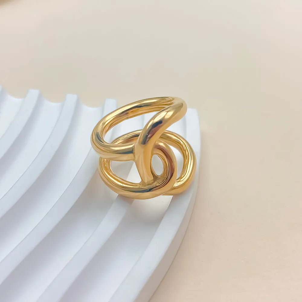 Geometric knotted open ring in stainless steel showing U-shape design and adjustable sizing