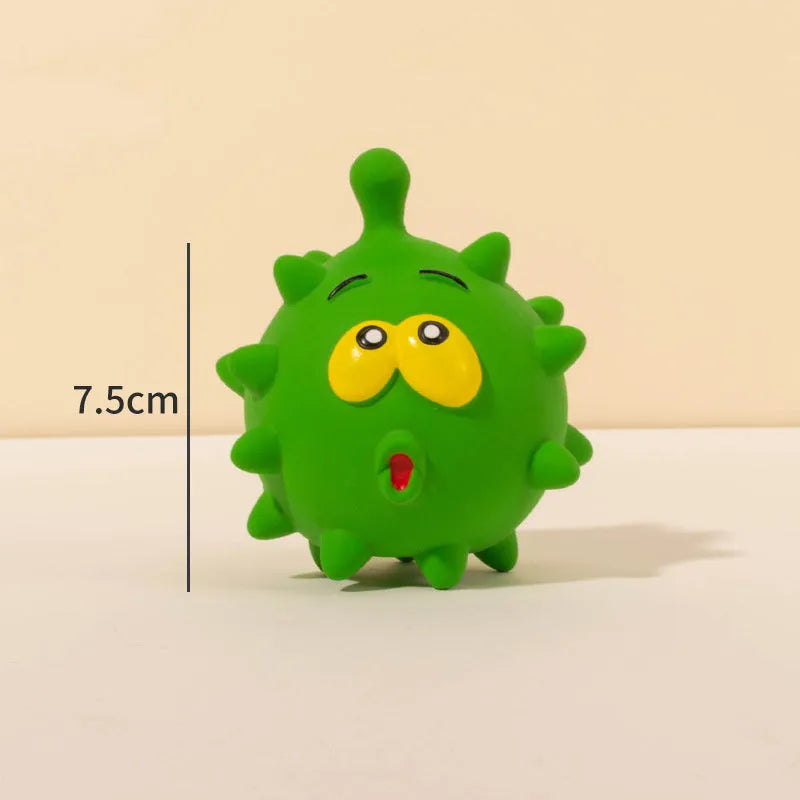 Set of four colourful latex squeaky dog balls with cute faces on a textured surface.