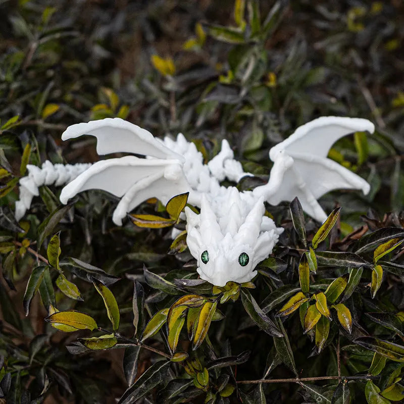 Red and gold 3D printed dragon wings toy decoration on a white background.