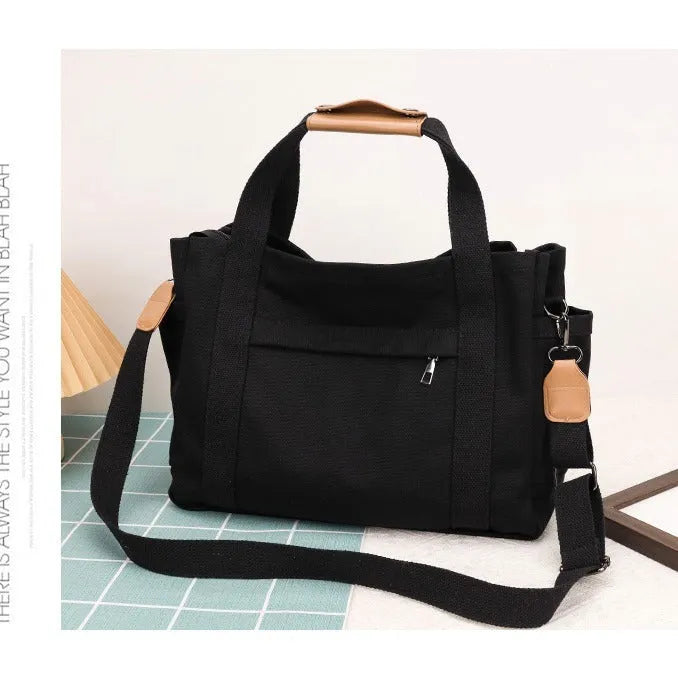 Large khaki canvas tote bag for women with open top showing internal laptop and camera pockets
