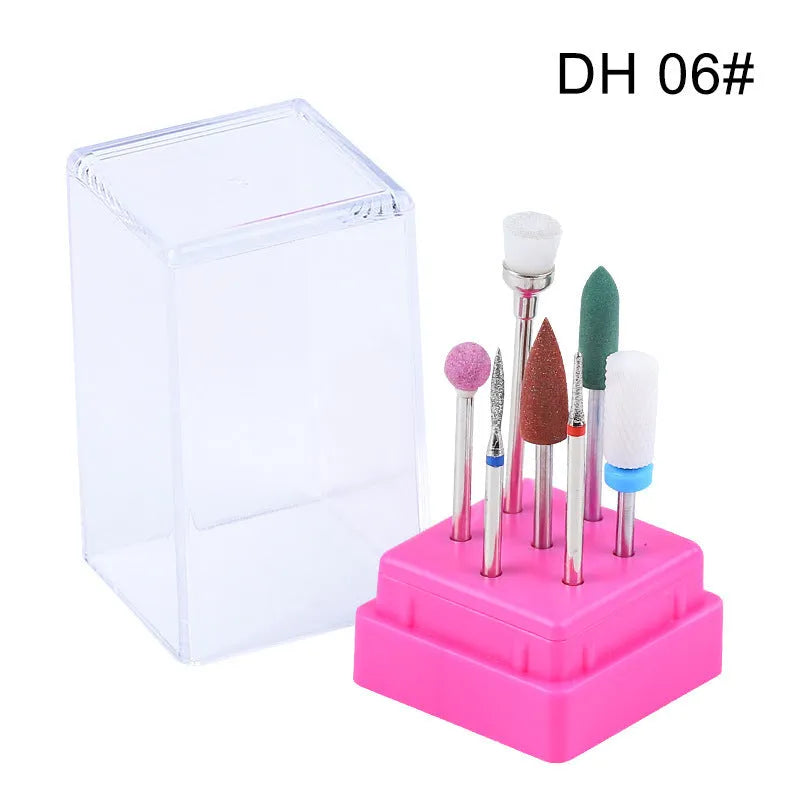Set of seven tungsten steel nail drill bits and a brush in a clear plastic case.