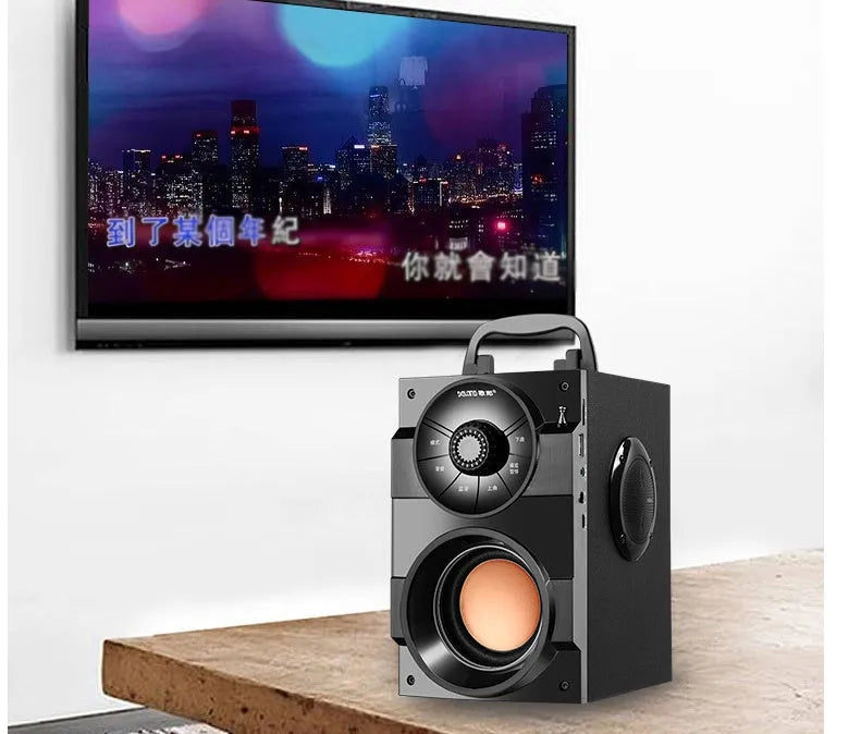 Black portable mini home audio system with subwoofer, satellite speakers, and a connected USB charging cable.