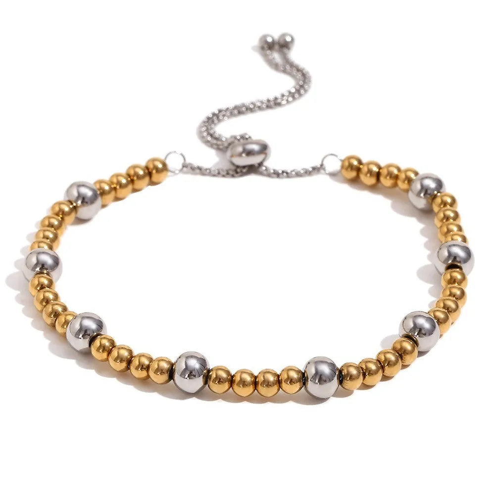 Gold electroplated women's jewellery set with geometric earrings, bracelet, and necklace on stainless steel