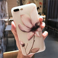 Black embossed iPhone case with a single white floral design on the back.