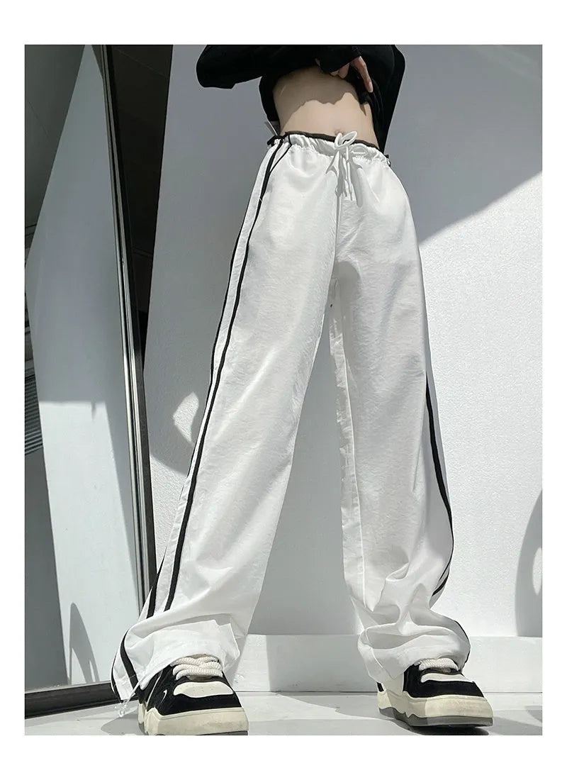 Women's straight leg trousers with ribbon waist and parallel bars contrast detailing in navy blue