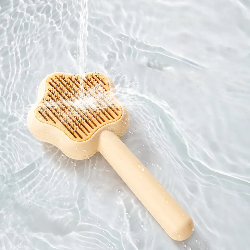 Self-cleaning stainless steel cat comb in green colour measuring 20cm long by 9.5cm wide