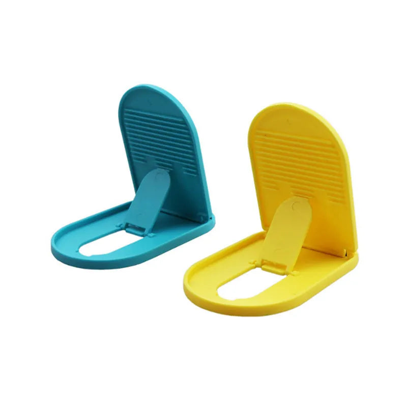 Plastic mobile phone stand with adjustable bracket in six colour options on a wooden desk
