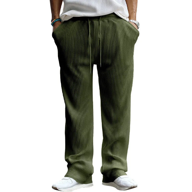 Man wearing loose-fit, high-waist, straight-leg casual trousers in a striped pattern.