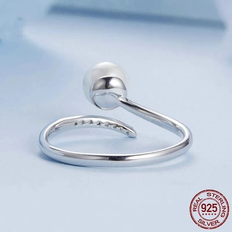 Adjustable S925 sterling silver ring featuring a natural shell pearl on a polished band.