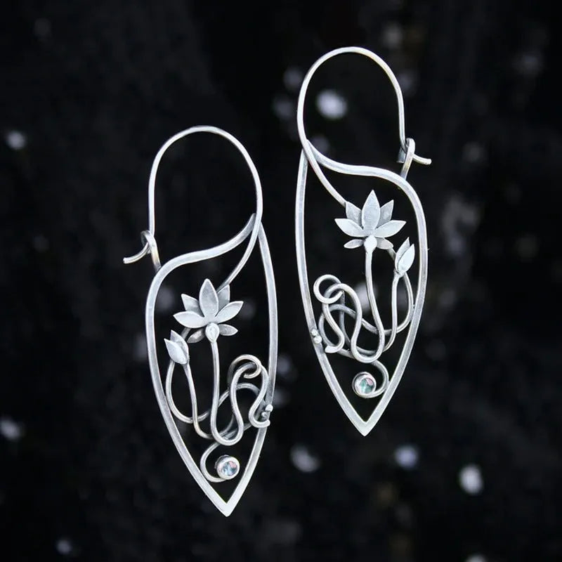 Silver lotus flower earrings with geometric shapes and rhinestone details