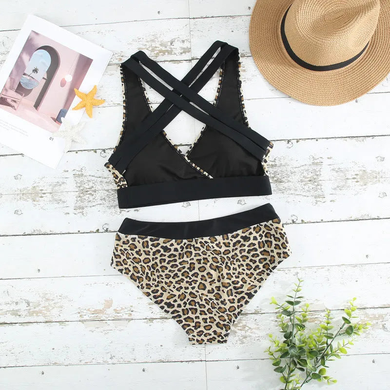 Women's leopard print V-neck cross banded bikini swimsuit on a hanger.