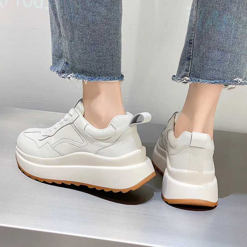Beige women's low-top leather shoes with cross-strap detail and English muffin heel.