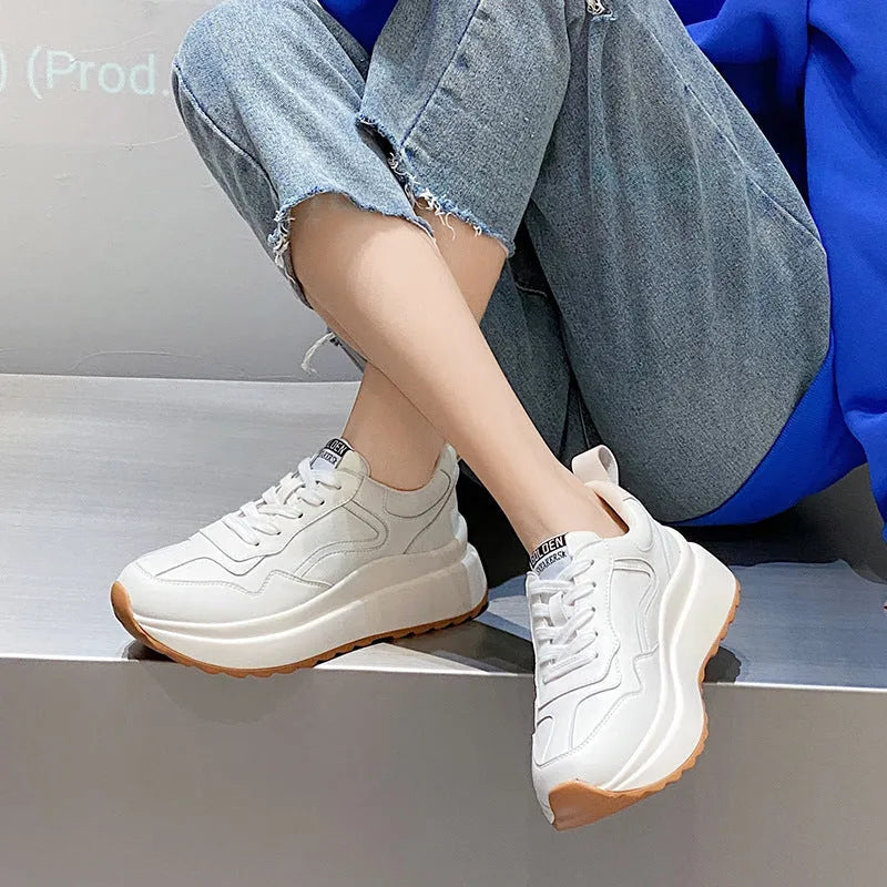 Beige women's low-top leather shoes with cross-strap detail and English muffin heel.