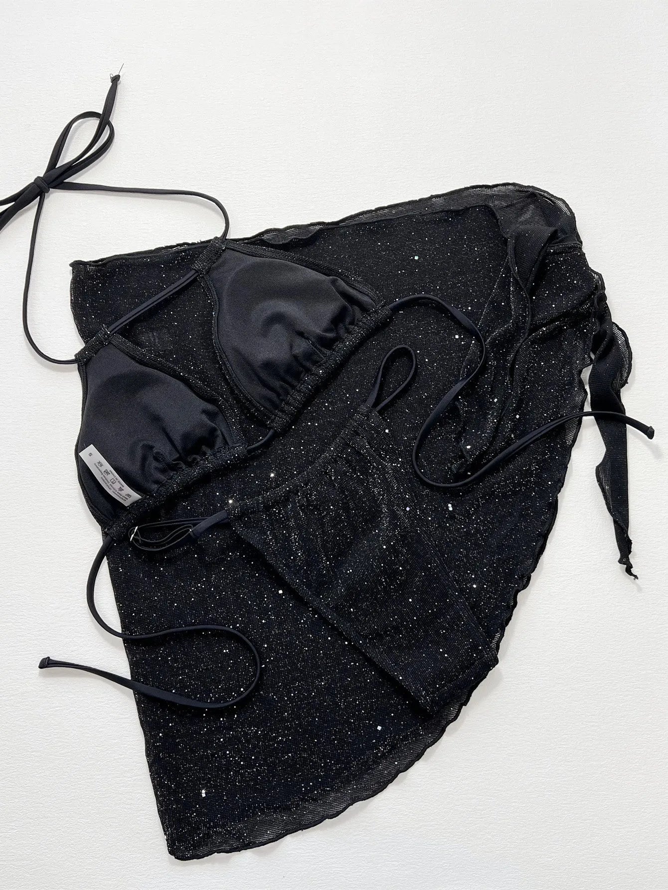 Black three-piece bikini swimsuit set with matching top and shorts on Asian sizing mannequin