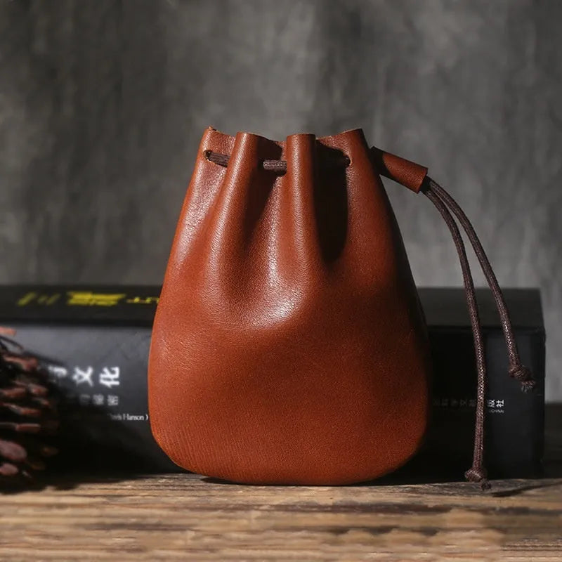 Vintage cowhide drawstring bundle wallet in genuine leather showing retro style and sewing thread detail.