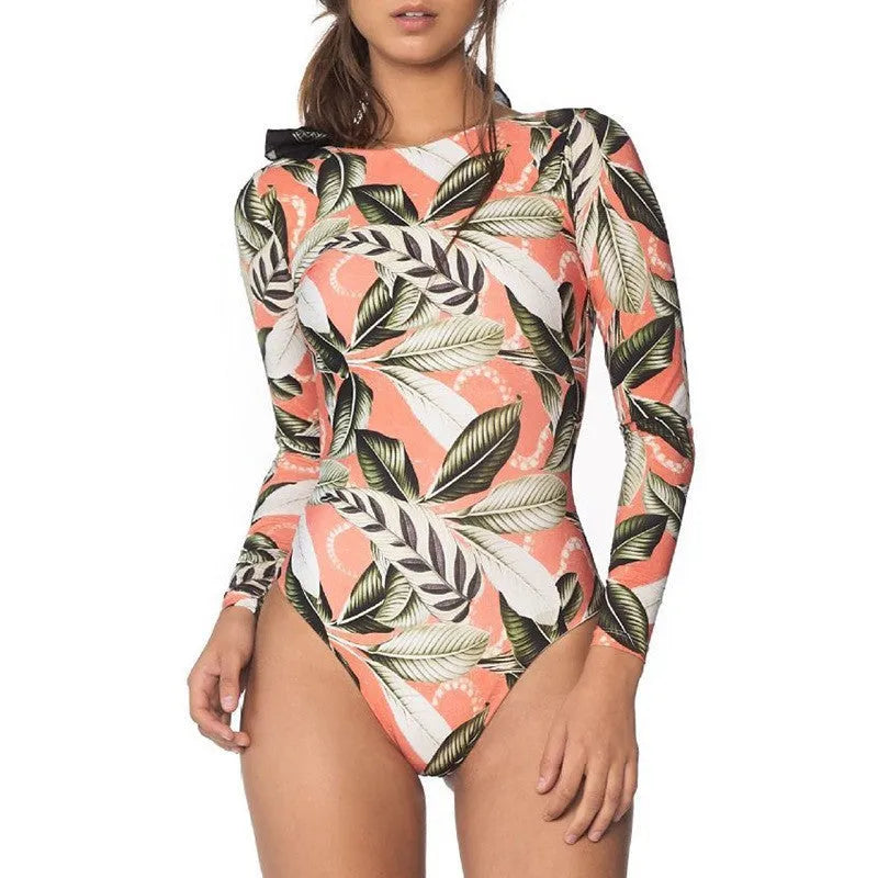 Women's backless one-piece swimsuit with green leaf print pattern, shown on a model.